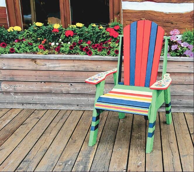 A colorful chair and colorful flowers